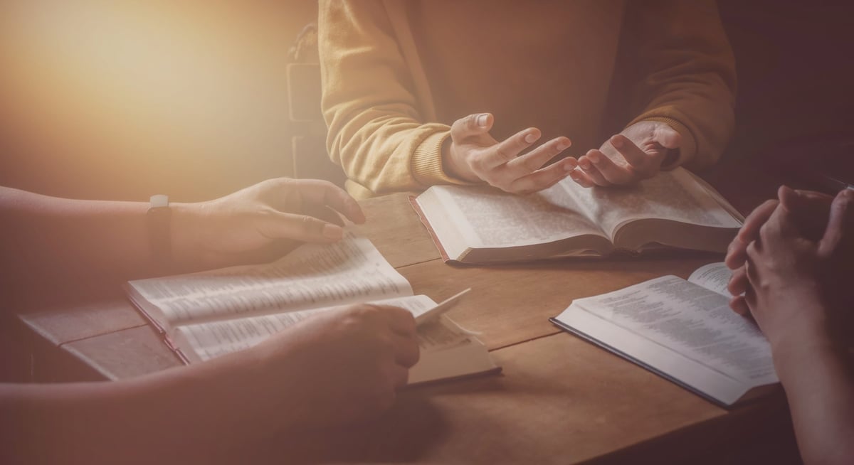 A diverse group studying the Bible together in a Sunday school classroom