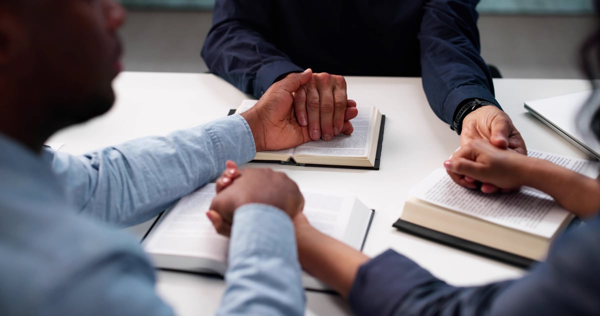 A diverse community studying the Bible and praying together