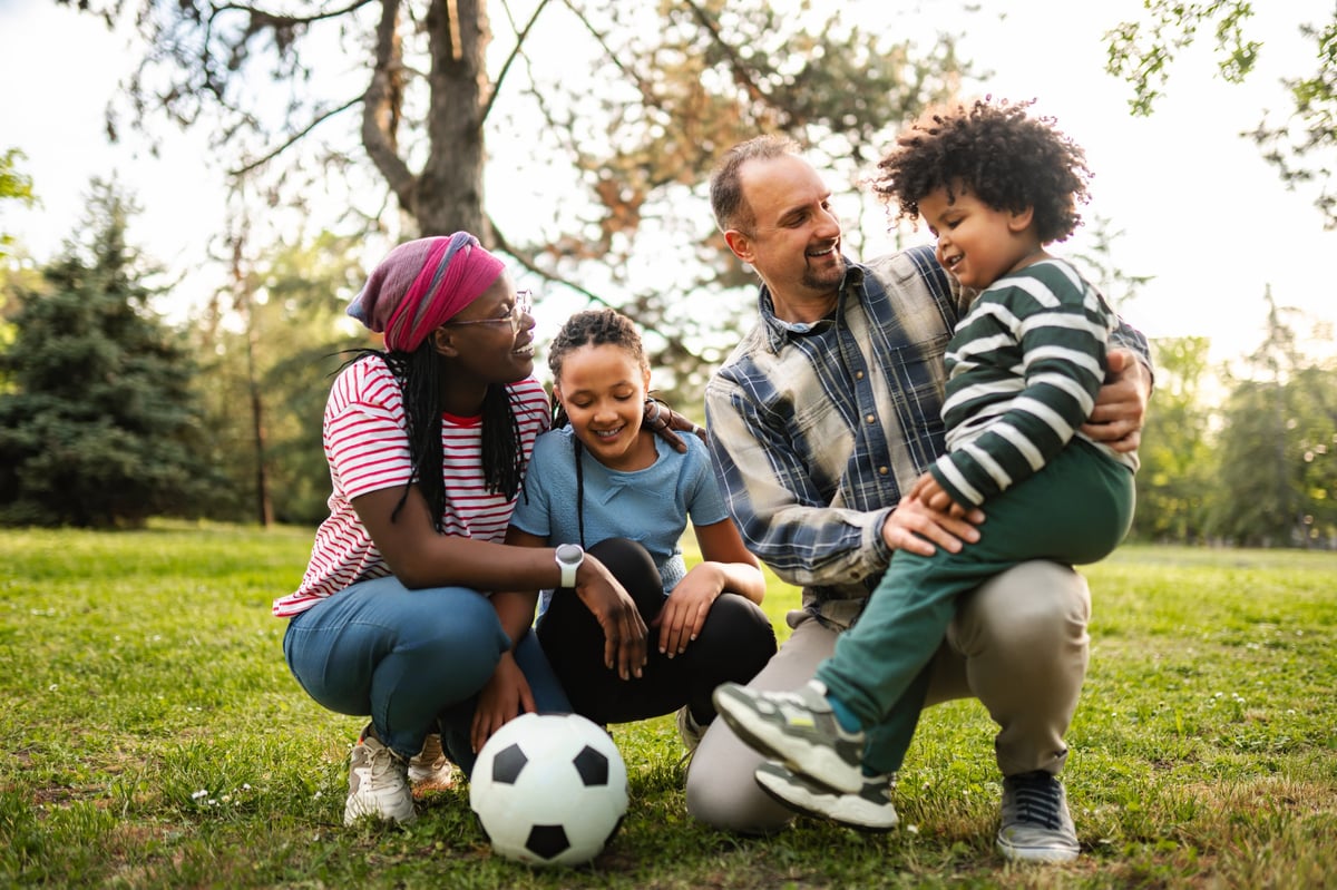 Parents and children smiling and enjoying time together outdoors