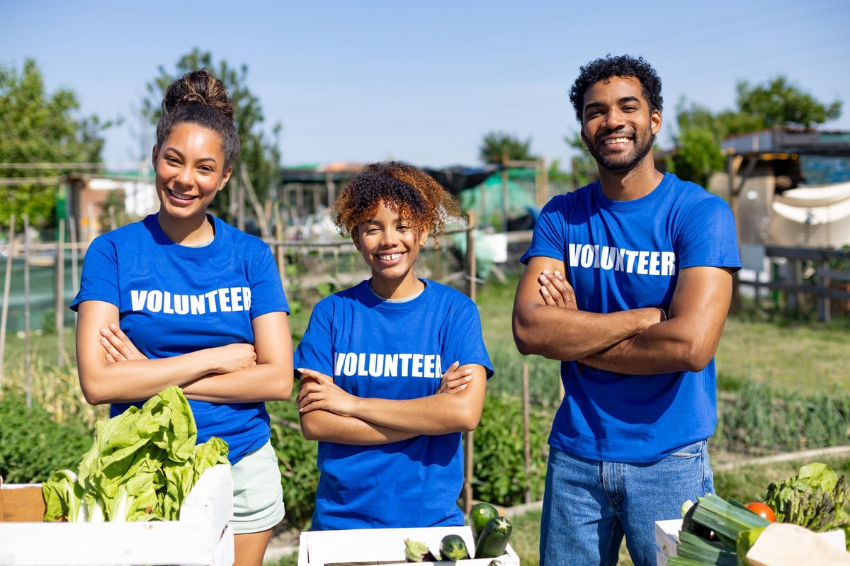 A diverse team of volunteers working together in a community garden