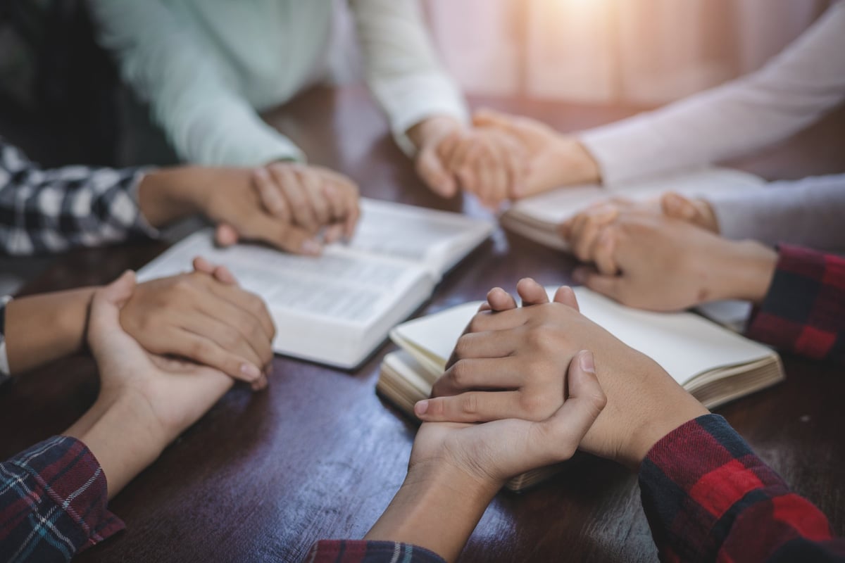A diverse religious community joining in prayer together